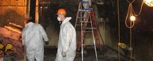 Water Damage Restoration Technician Working In Basement in Cary, NC